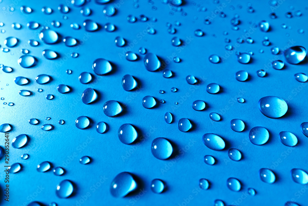 Close up Blue glass surface with clear water drops, background