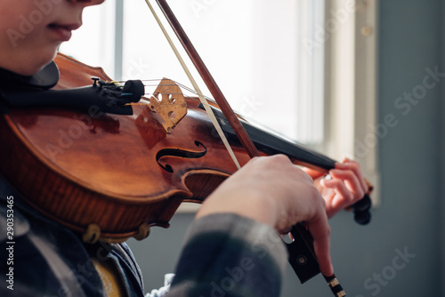 Young girl practicing violin photo