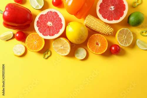 Different vegetables and fruits on yellow background  top view