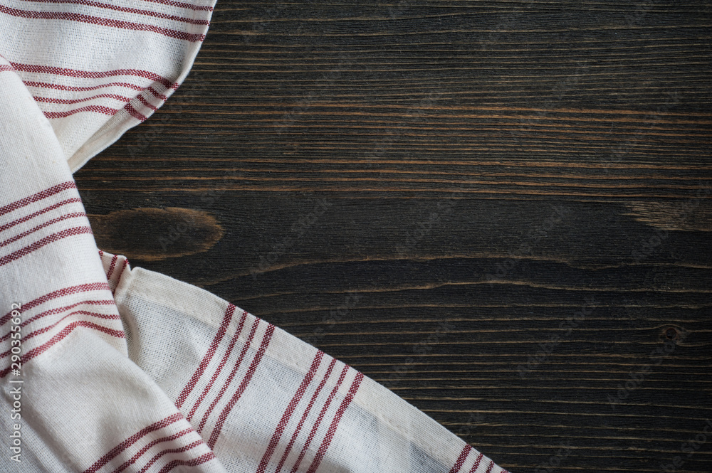 Dark wooden background with white napkin Dark wooden background with white napkin