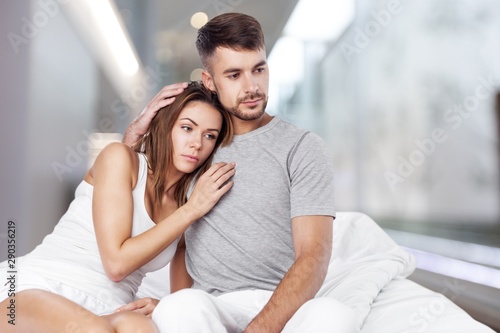 Free Download Dissatisfied beautiful young woman in bed with sad expression on her face, sex problems in long relationship or marriage while man sleeping. Saturation or satiety between caucasian couple, disinterest - GFXLoad
