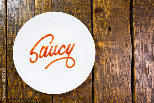Saucy written in sauce on a plate