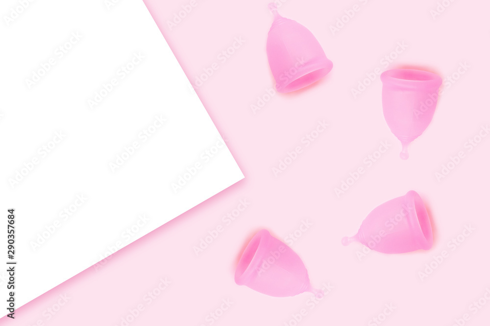 Pink menstrual cups on pink background. Flat lay, top view. copy space.
