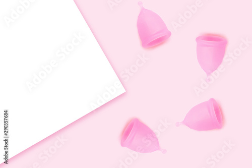 Pink menstrual cups on pink background. Flat lay, top view. copy space.