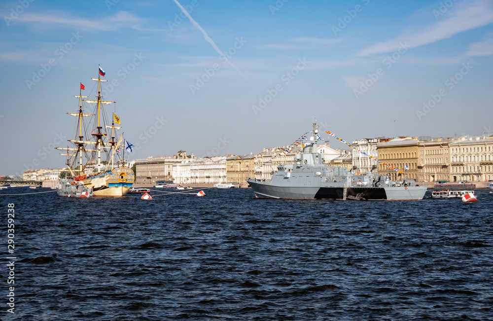 Sailboat and warship at the celebration of the Navy in St. Petersburg