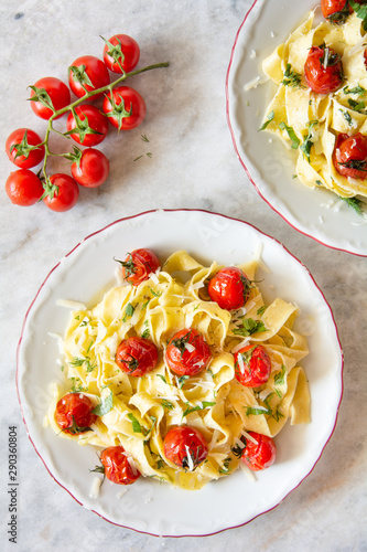 Tagliatelle pasta with oven roasted tomatoes and Parmesan cheese photo