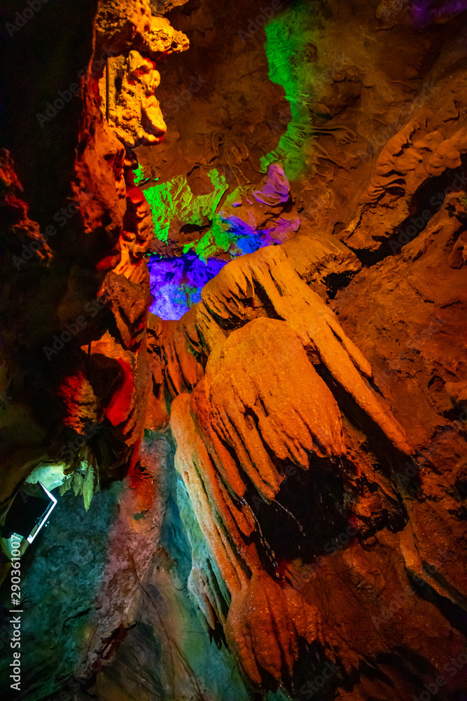 Beautiful illuminated multicolored stalactites in Danzhou Stone Flower Caves, Geopark next to Haikou, Hainan, China