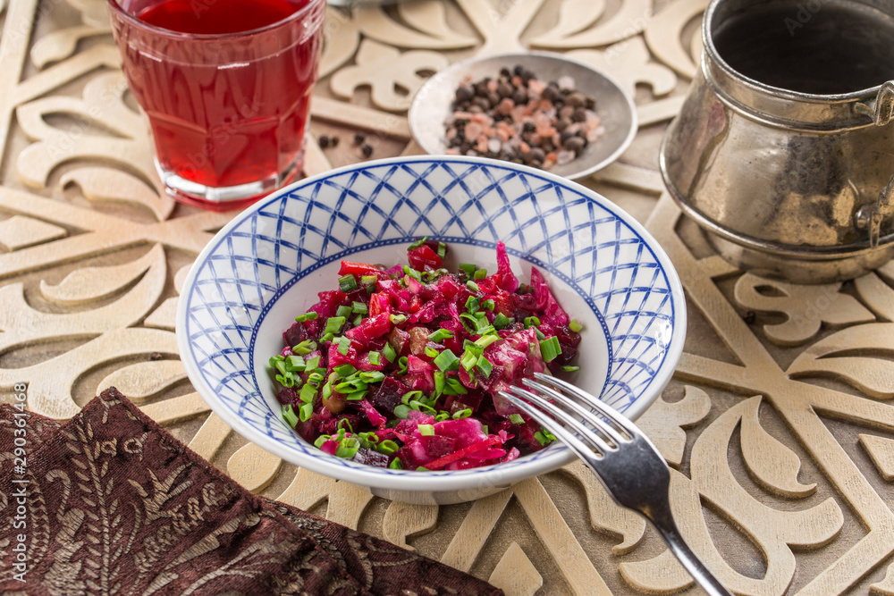beetroot salad vinaigrette with green onion on plate on oriental wooden background beetroot salad vinaigrette with green onion on plate on oriental wooden background