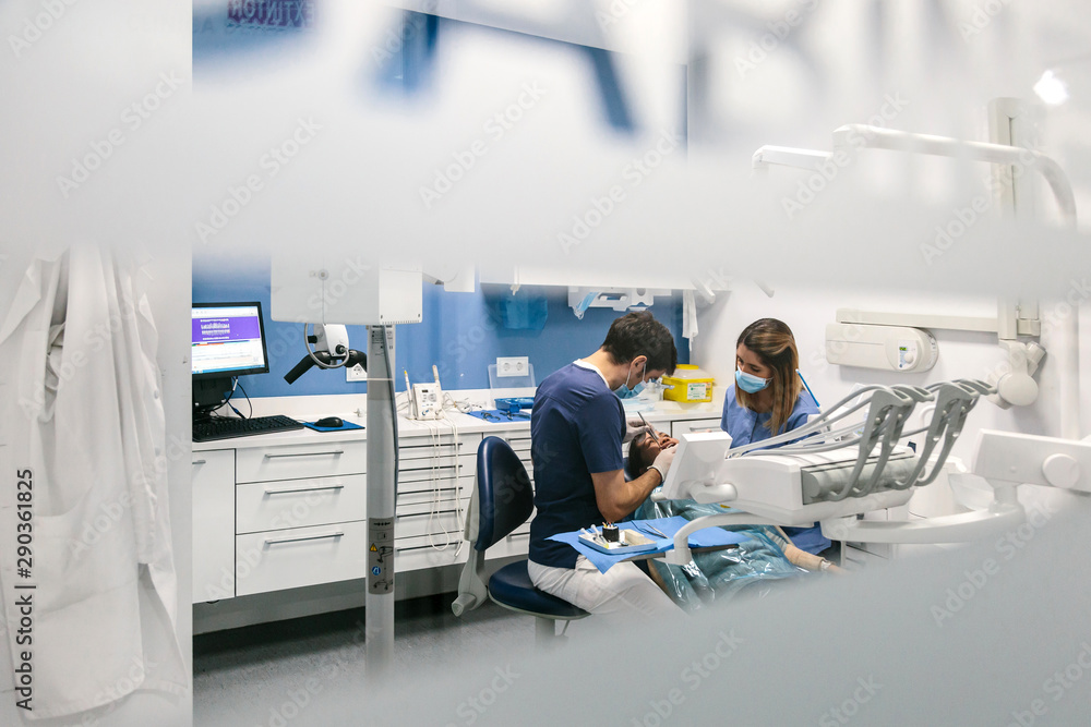 Dentists working on patient Dentists working on patient