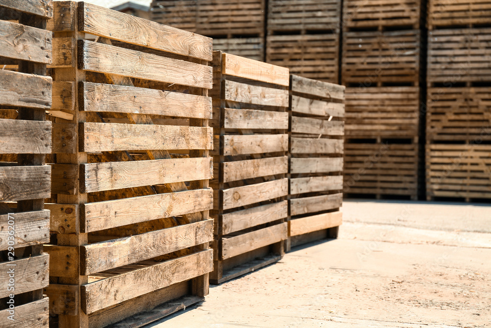 Old empty wooden crates outdoors on sunny day. Space for text Old empty wooden crates outdoors on sunny day. Space for text