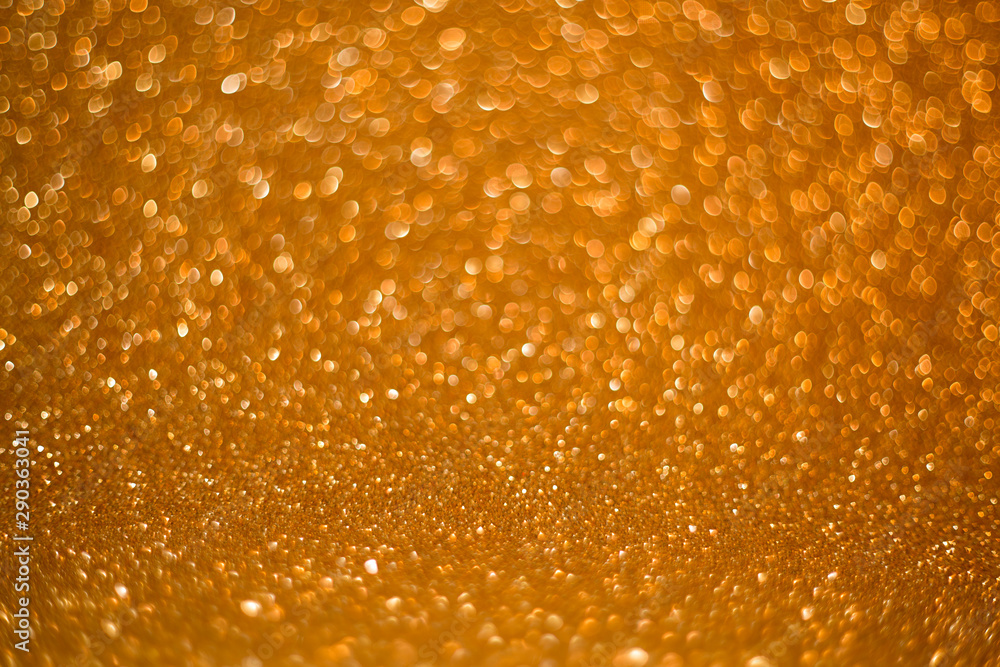 Gold giltter texture abstract background.Gold Festive Christmas twinkled bright background with bokeh defocused golden lights Gold giltter texture abstract background.Gold Festive Christmas twinkled bright background with bokeh defocused golden lights