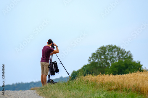 Nature photographer takes landscape photos in summer
