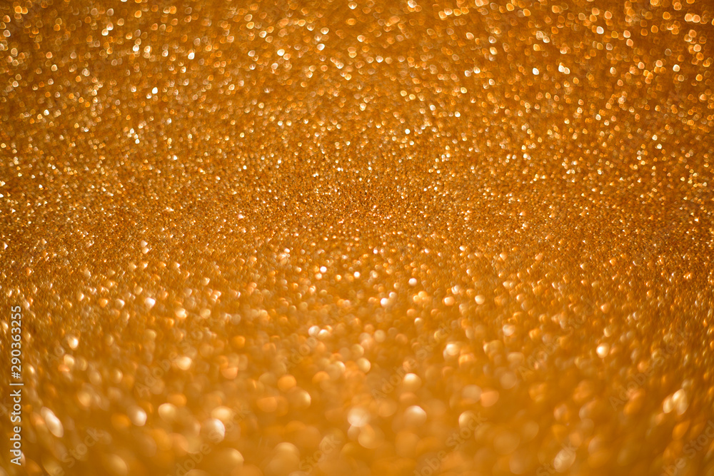 Gold giltter texture abstract background.Gold Festive Christmas twinkled bright background with bokeh defocused golden lights