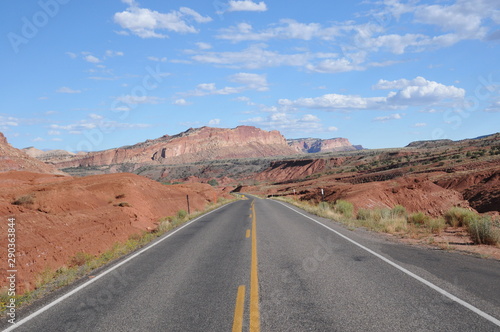 Utah highway depicting a long empty road with dramatic landscape