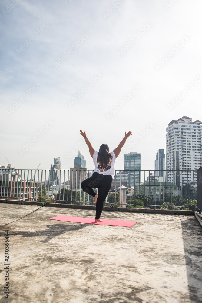 Beautiful woman practicing yoga on the rooftop Beautiful woman practicing yoga on the rooftop