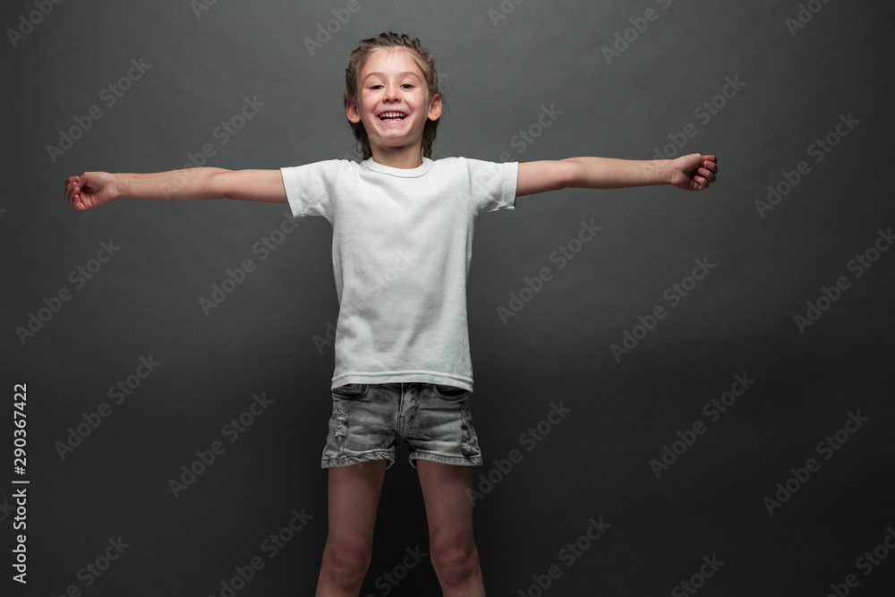 Kid girl wearing white t-shirt with space for your logo or design over gray background