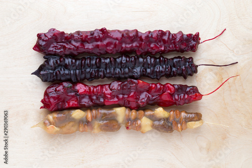 Churchkhela on a wooden background. Georgian sweet close-up. photo