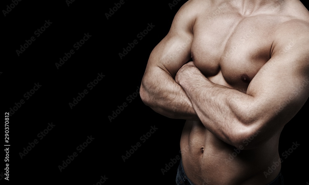Close up of perfect male body isolated on black background with copy space Close up of perfect male body isolated on black background with copy space