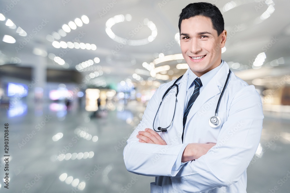 Young female doctor with stethoscope on blurred hospital background Young female doctor with stethoscope on blurred hospital background