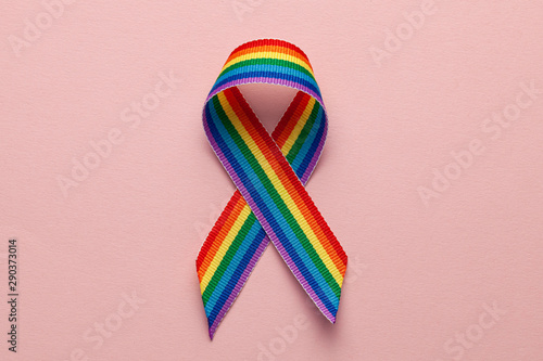 LGBT rainbow ribbon pride symbol. Stop homophobia. Pink background photo