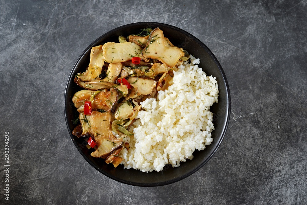 Fried oyster mushrooms with chili pepper, garlic and soy sauce with boiled rice. Healthy food. Fried oyster mushrooms with chili pepper, garlic and soy sauce with boiled rice. Healthy food.