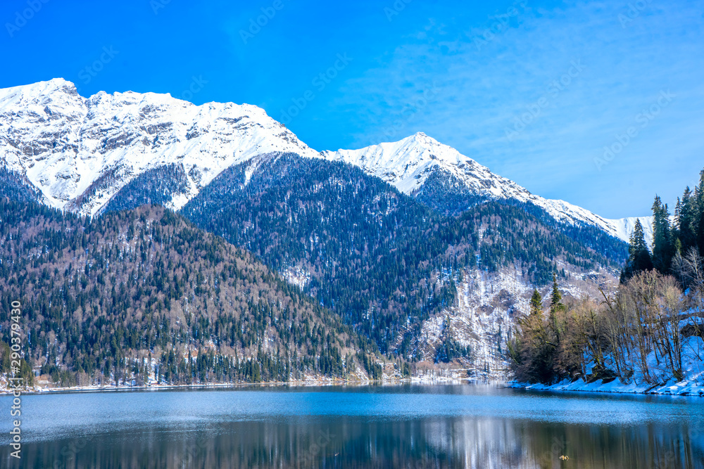 High mountains covered with snow on Lake Ritsa in Abkhazia