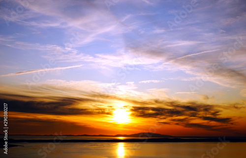 Fototapeta Naklejka Na Ścianę i Meble -  Red sunset above sea surface and dramatic sky