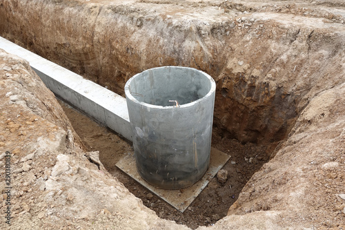 Laying utilities. Concrete well for communications buried in the ground