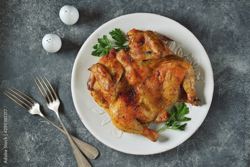 Spatchcocked barbecue chicken with spices and garlic Spatchcocked barbecue chicken with spices and garlic