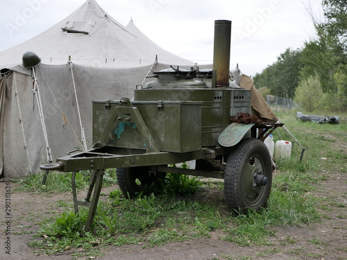 Military marching kitchen outdoors on a summer day on a leafy background .  world war II technology. Logistical support of troops.