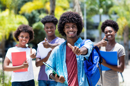 Successful african american university student with group of african american students