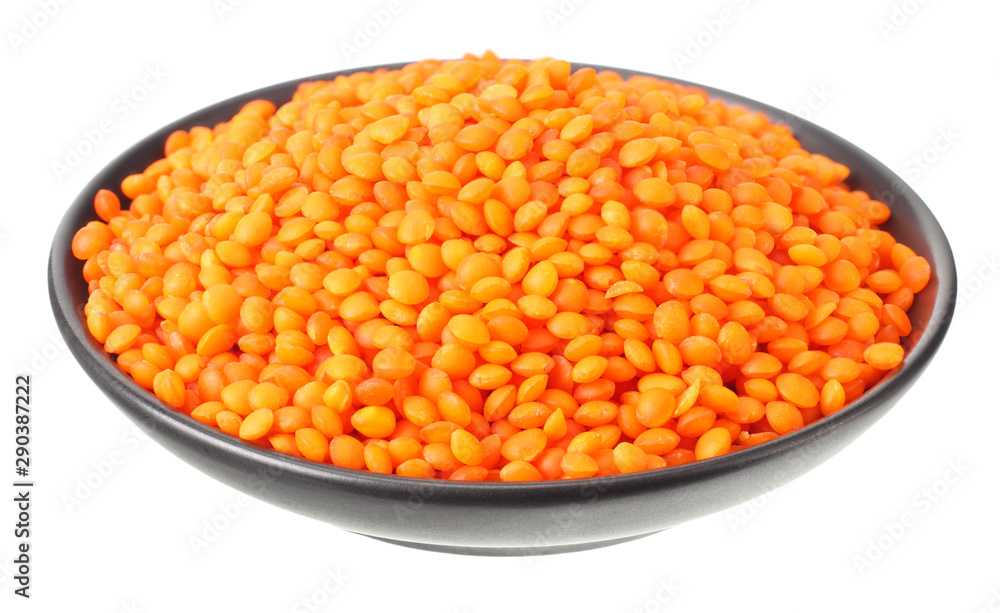 Pile lentil in black bowl isolated on white background