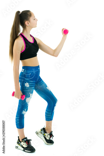Teenage girl with dumbbells in hands © lotosfoto