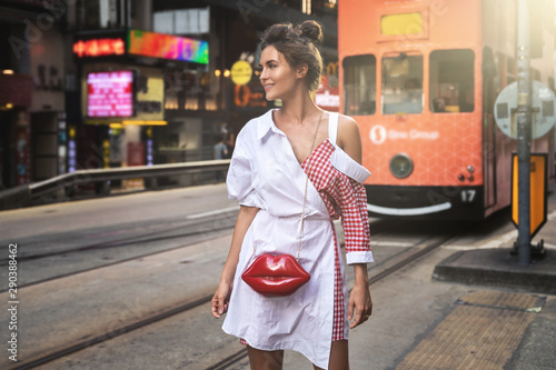 Stylish woman  walking along the street of Hong Kong city