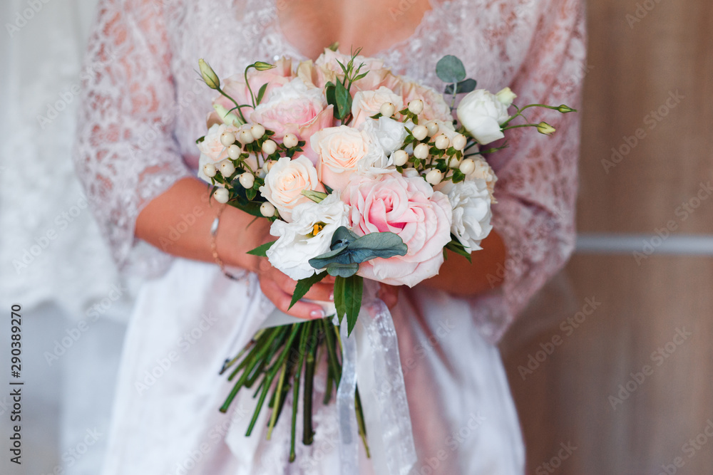 Pale pink bridal bouquet with delicate pink flowers.