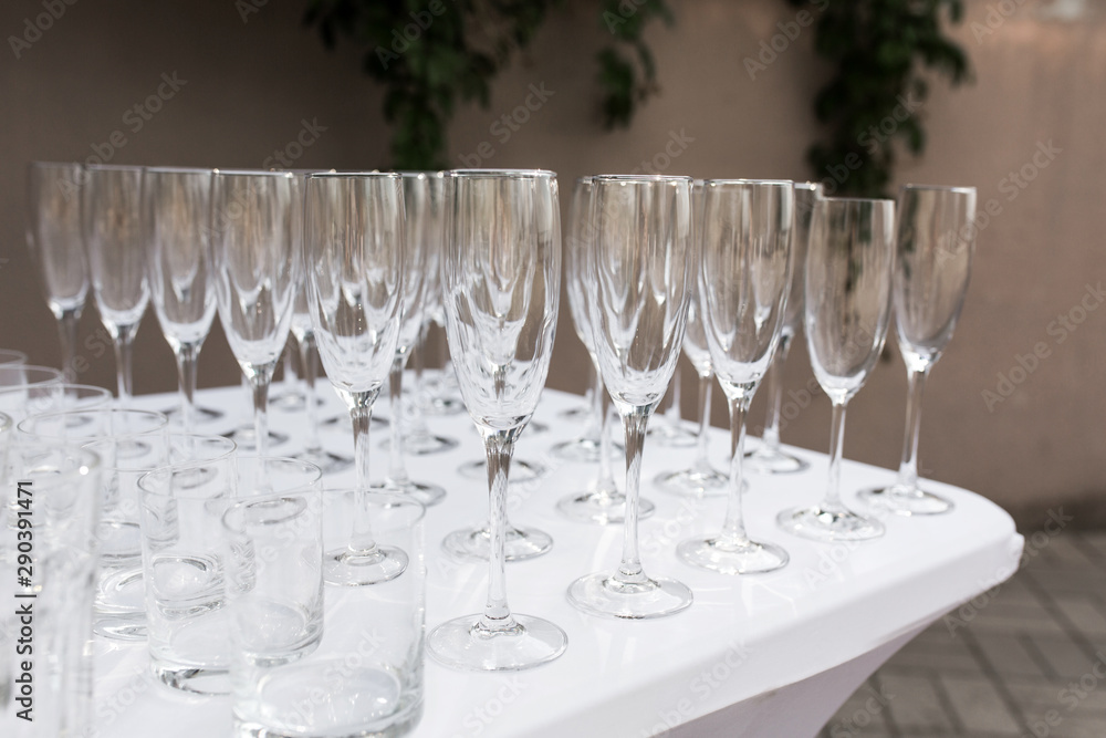 Many empty clean glasses for guests at the buffet festive wedding table Many empty clean glasses for guests at the buffet festive wedding table