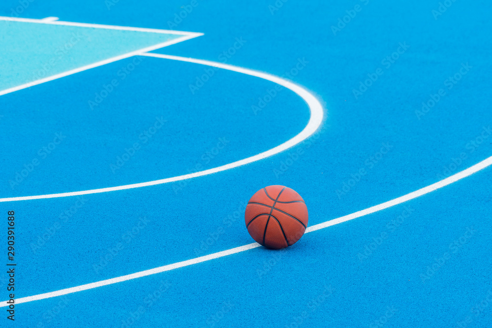 Orange Basketball ball on the blue surface Orange Basketball ball on the blue surface