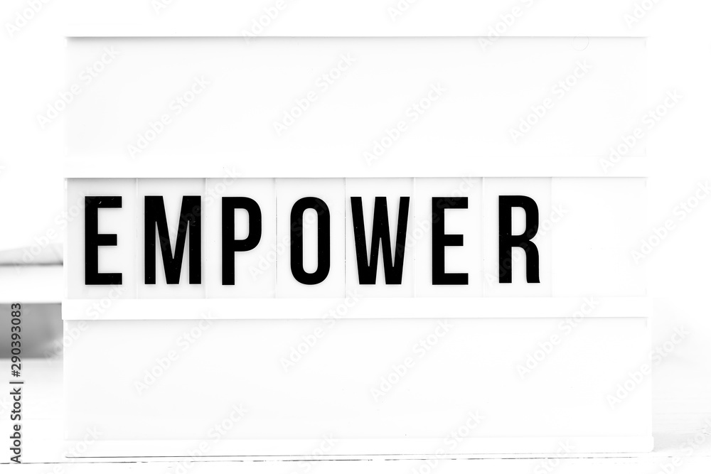 Empower flat lay on a wooden white background. Motivational business start up board Empower flat lay on a wooden white background. Motivational business start up board