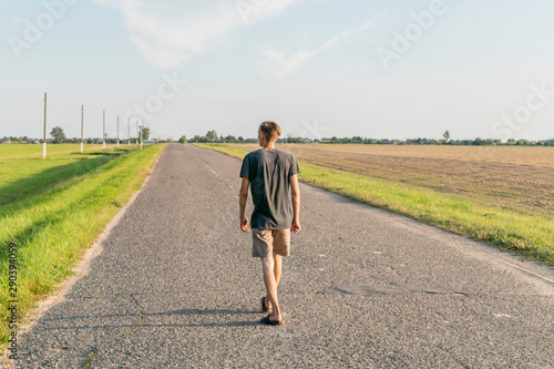 Young guy walking on the road in the open © Сергей Старостов