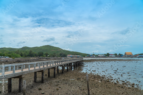 The Samae San Pier Bridge is long and connects to the pier to Samae San Island. .You can walk to see coral reefs and fish in the tide.. © Narong Niemhom