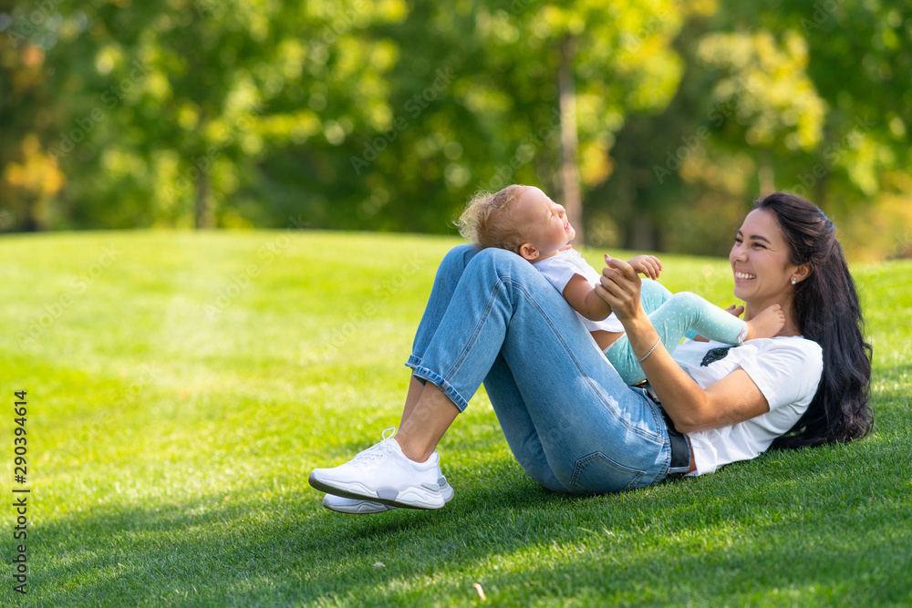 Loving young mother laughing with her infant child Loving young mother laughing with her infant child