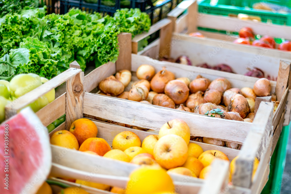 Fresh fruits and vegetables in wooden pallets at a farmers market