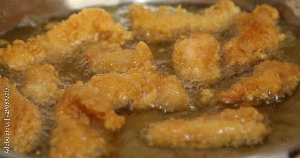 Golden color chicken wings cooking into a wok Golden color chicken wings cooking into a wok
