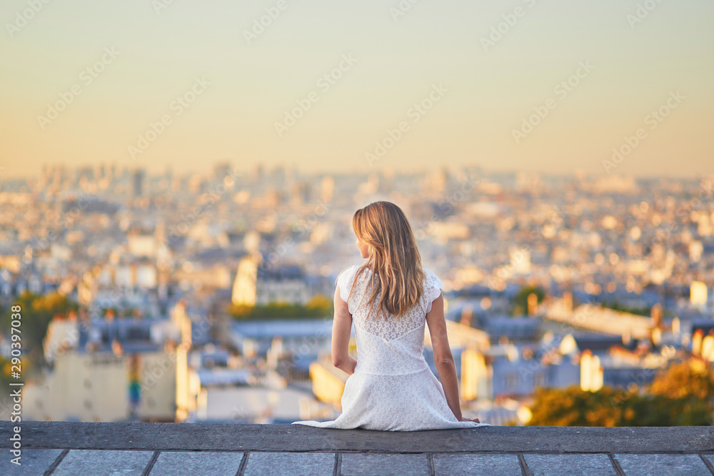 woman in white dress walking on famous Montmartre hill in Paris