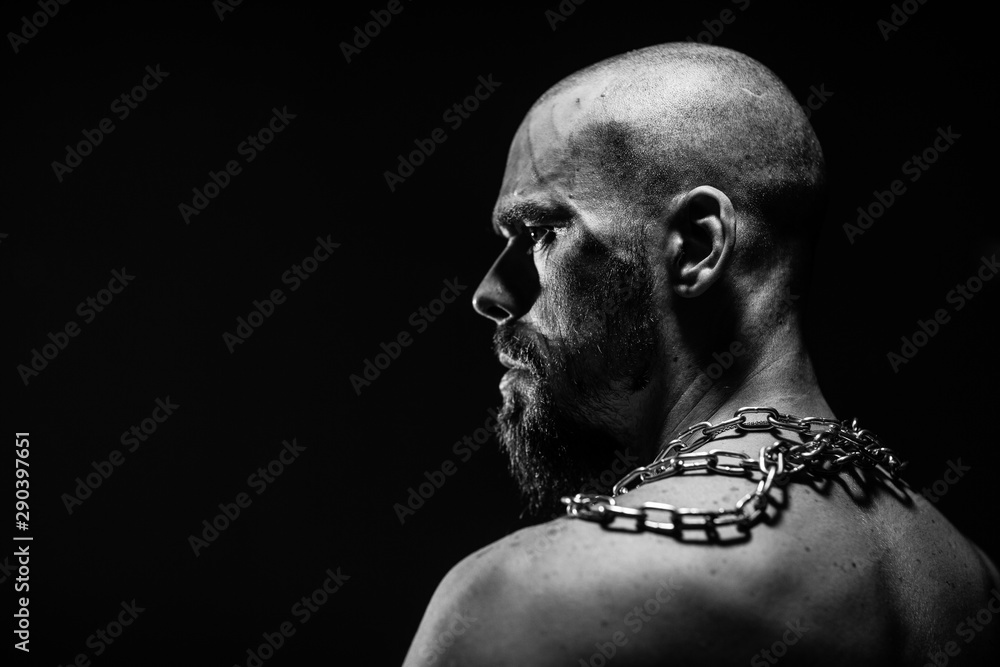 black and white portrait of a brutal man tearing the chain