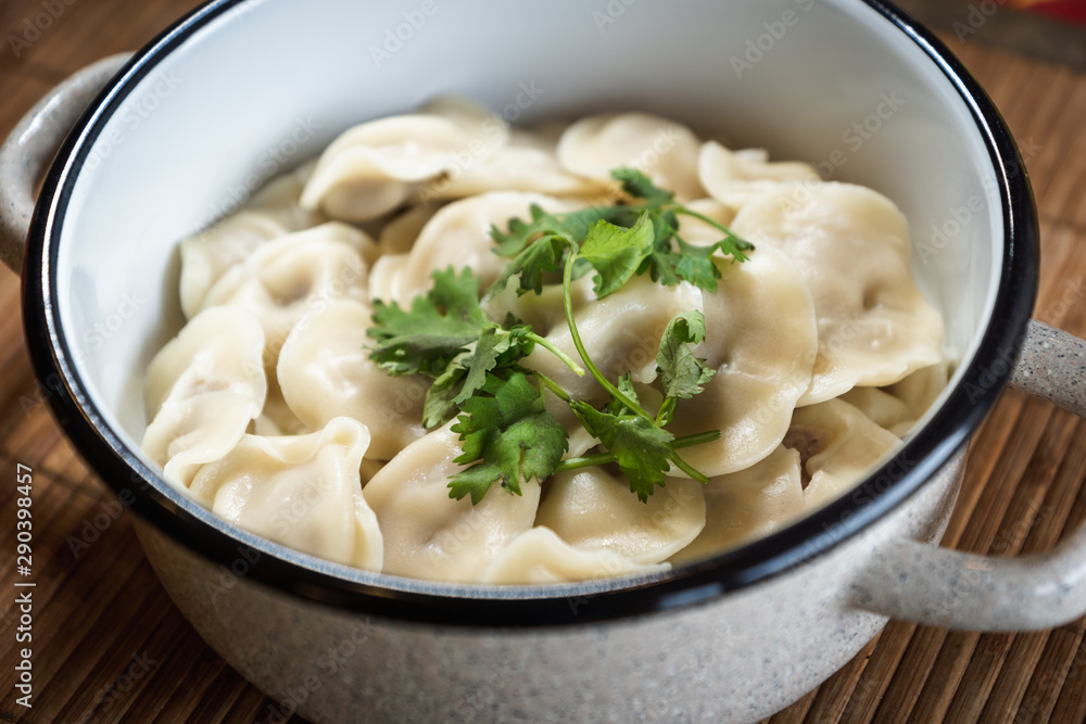 Pelmeni, traditional Russian dumpling dish with meat on table - selective focus, top down photo Pelmeni, traditional Russian dumpling dish with meat on table - selective focus, top down photo