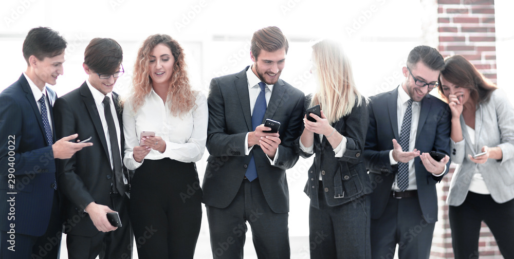 business team looking to smartphone in office