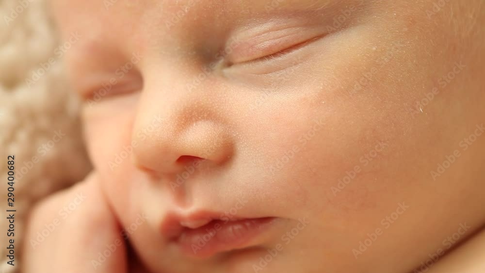 Stationary close-up of a sleeping Caucasian newborn's face Stationary close-up of a sleeping Caucasian newborn's face