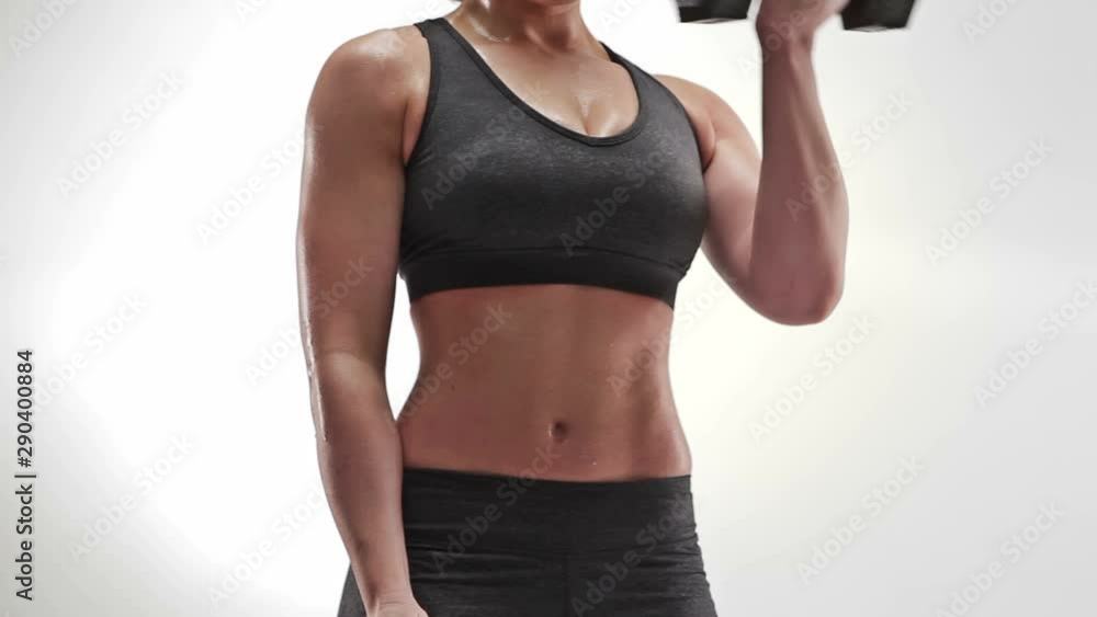Athletic caucasian woman curling weights Athletic caucasian woman curling weights