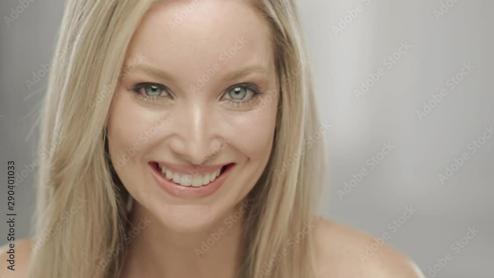 Caucasian blonde woman in studio smiling and laughing at camera Caucasian blonde woman in studio smiling and laughing at camera